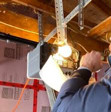 Dallas technician servicing garage door opener motor - hands-on professional repair